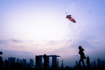 Singapore, Singapore - August 22th, 2015 The kids are playing with the kite on top of the Marina Barrage. Singapore, Singapore - August 22th, 2015 The kids are playing with the kite on top of the Marina Barrage.