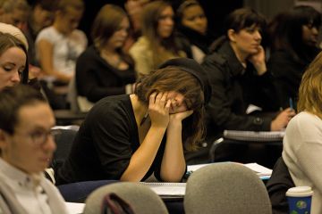 Woman sleeping in lecture theatre Woman sleeping in lecture theatre