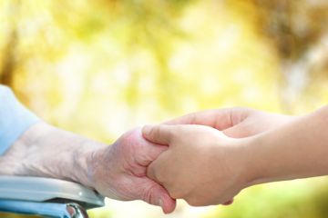 Old woman olding carer's hand Old woman olding carer's hand