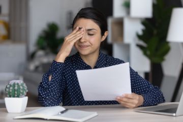 Stressed upset employee holding document with bad dismissal news