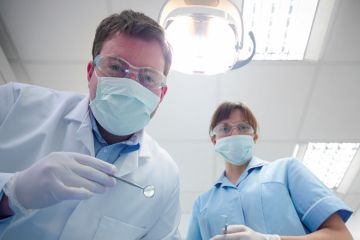Student and dentist in dental surgery Student and dentist in dental surgery