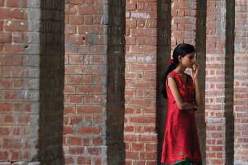 Student waiting in corridor, University of Delhi Student waiting in corridor, University of Delhi