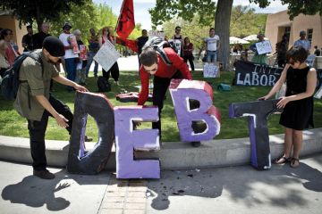 Students holding letters spelling 'Debt', University of New Mexico