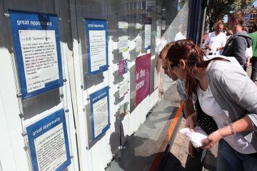 Students look at job vacancies on display in the window Students look at job vacancies on display in the window to illustrate ‘Radical rethink’ needed as work vies with study