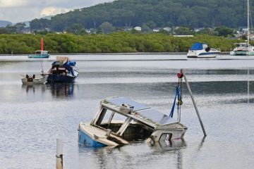 Half sunken wooden boat with just the cabin showing
