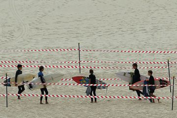 Surfers carry their boards on Bondi Beach when it reopened after a five-week closure in Sydney on April 28, 2020, amid the coronavirus pandemic. Surfers carry their boards on Sydney’s Bondi Beach after it reopened after a five week closure, autonomy, free from meddling