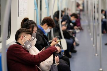 People on subway wearing surgical masks