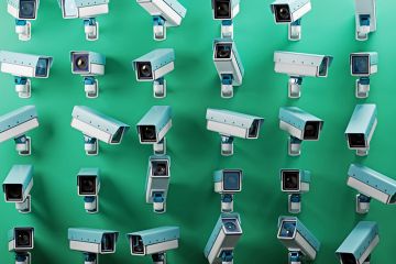 An array of multiple security cameras mounted on a green wall, symbolising surveillance, security, and monitoring. To illustrate that franchise partners must be helped to improve, not just monitored. An array of multiple security cameras mounted on a green wall, symbolising surveillance, security, and monitoring. To illustrate that franchise partners must be helped to improve, not just monitored.