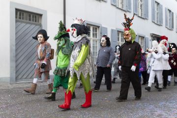 Switzerland, Basel, 8 March 2022. Small group of carnival participants in colorful costumes Switzerland, Basel, 8 March 2022. Small group of carnival participants in colorful costumes
