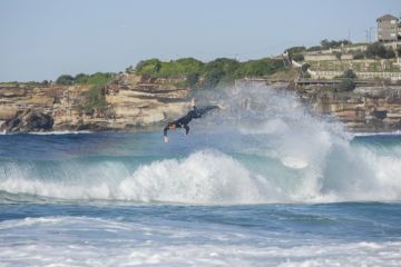 Sydney, Australia - May 21, 2017. Surfer wiping out at Tamarama Beach