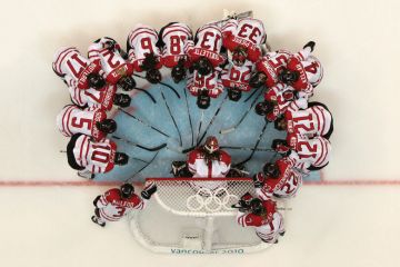 Team Canada in huddle on rink, Winter Olympic Games, 2010 Team Canada in huddle on rink, Winter Olympic Games, 2010