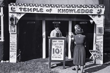 Historical photo of a fortune teller's booth, the Temple of Knowledge, showing advertising posters, admission taker, and two women customers waiting their turns. To illustrate that admissions on predicted A-level grades look foolish in AI era. Historical photo of a fortune teller's booth, the Temple of Knowledge, showing advertising posters, admission taker, and two women customers waiting their turns. To illustrate that admissions on predicted A-level grades look foolish in AI era.