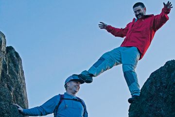 Man standing on another man's head