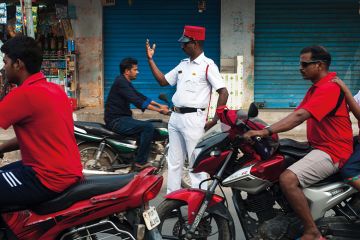 Policeman directing traffic on a street at Puducherry, India Policeman directing traffic on a street at Puducherry, India