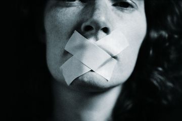 Woman with tape over her mouth Woman with tape over her mouth