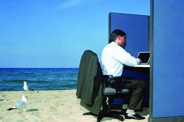Businessman working in office cubicle at beach Businessman working in office cubicle at beach