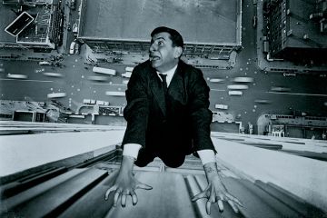 Man clinging on to outside of building