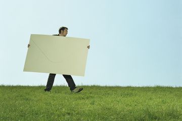 Man carrying giant envelope