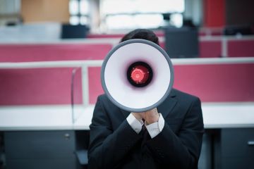 A person obscured by a megaphone A person obscured by a megaphone