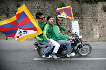 Exiled Tibetan protesters riding on motorbike Exiled Tibetan protesters riding on motorbike