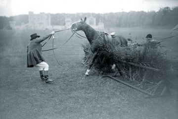 Man trying to make a horse get over a jump