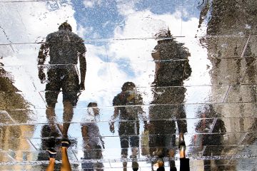 Reflection of human figures on a pavement