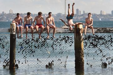 Children play on a shark net at Little Manly Cove, Australia Children play on a shark net at Little Manly Cove, Australia