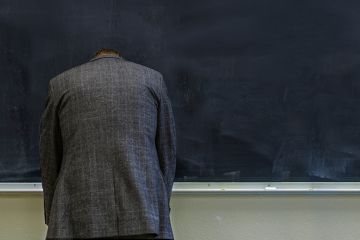 teacher frustrated at blackboard