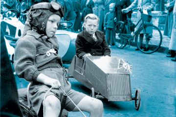 Young competitors make their way to the starting point on an assortment of vehicles. Young competitors make their way to the starting point on an assortment of vehicles.