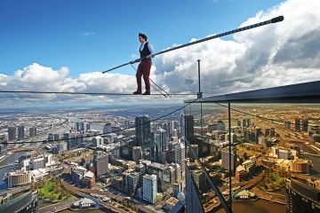 High-wire artist Kane Petersen successfully walks a tightrope 300 metres above the ground at Eureka Skydeck in Melbourne, Australia. 