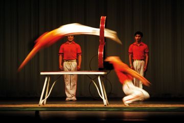 Acrobats jumping through hoops