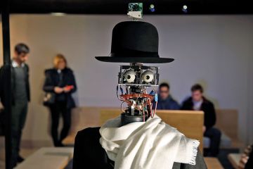 Image of a robot wearing a bowler hat and a scarf Image of a robot wearing a bowler hat and a scarf