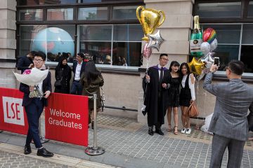 Friends and family of a 21 year-old Law graduate from Hong Kong, celebrate her graduation with a 2:1 degree outside the London School of Economics Friends and family of a 21 year-old Law graduate from Hong Kong, celebrate her graduation with a 2:1 degree outside the London School of Economics