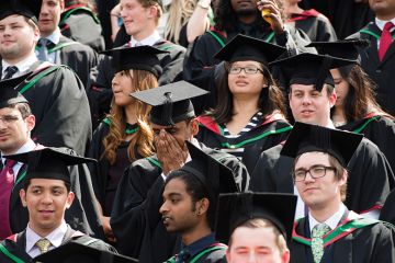 Graduating students in mortarboards Graduating students in mortarboards