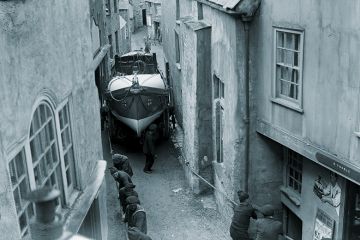 The Port Isaac Cornwall lifeboat being dragged through the very narrow streets of the town at its launch.