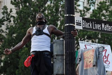 Man screams near a street sign that has been renamed 'Black Lives Matter Plaza' near the White House during a demonstration against racism and police brutality, in Washing Man screams near a street sign that has been renamed 'Black Lives Matter Plaza' near the White House during a demonstration against racism and police brutality, in Washing