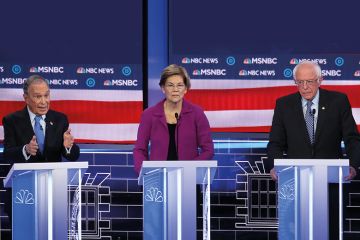 Democratic presidential candidate former New York City Mayor Mike Bloomberg, speaks as Sen. Elizabeth Warren (D-MA) and Sen. Bernie Sanders (I-VT) listen during the Democratic presidential primary debate at Paris Las Vegas on February 19, 2020.