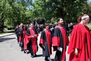 Toronto, Canada, June 8, 2010. Graduates at the University of Toronto walking to the ceremony where they will receive their diplomas. The red striped gowns indicate that they will receive doctorates