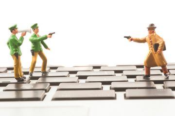 Toy cops and robber on keyboard