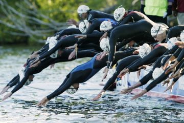 Triathlon swimmers at the start of a race Triathlon swimmers at the start of a race
