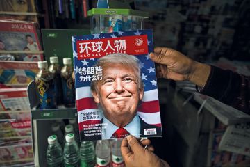 A Chinese magazine with a cover story that translates to "Why did Trump win" is seen with a front cover portrait of Donald Trump