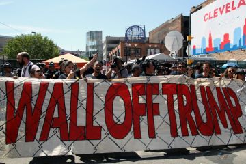 Cleveland, Ohio, USA - July 20, 2016: Participants in the 'Wall Off Trump' immigration march and rally demonstrate outside the Quicken Loans Arena, site of the Republican National Convention, on its third day. 
