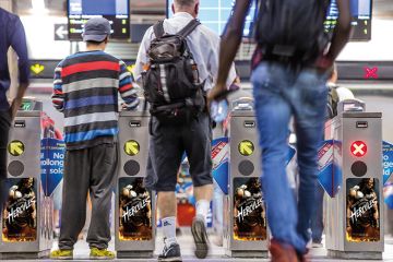 People passing through turnstiles