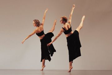 Two women dancing side by side