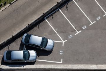 Two similar silver cars parked on one place