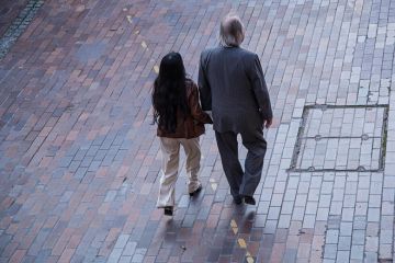 A man and a woman walking in the street A man and a woman walking in the street