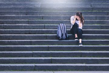 Upset young female student illustrating article about Irish Research Council policy against bullying and harassment