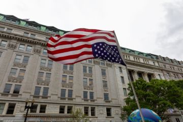 Upside down national flag of the USA waving in the wind