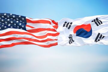 American and Korean flags fly side-by-side American and Korean flags fly side-by-side