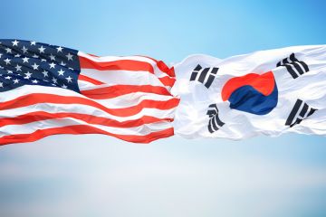 American and Korean flags fly side-by-side